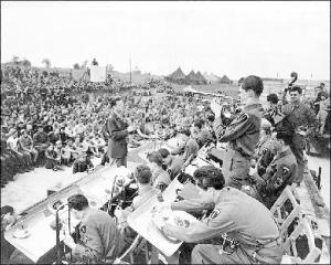 Glenn Miller conducts at an open air concert